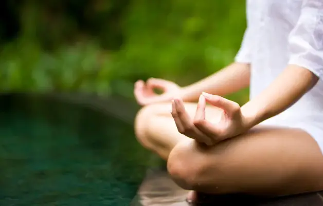 Person meditating using neuromeditation techniques supported by qEEG technology to enhance relaxation and emotional regulation.